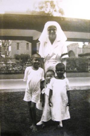 Newsletter editor’s mother Nursing Sister D.M. Preston with local children at Penang Hospital