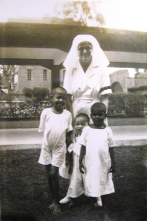 Newsletter editor’s mother Nursing Sister D.M. Preston with local children at Penang Hospital 